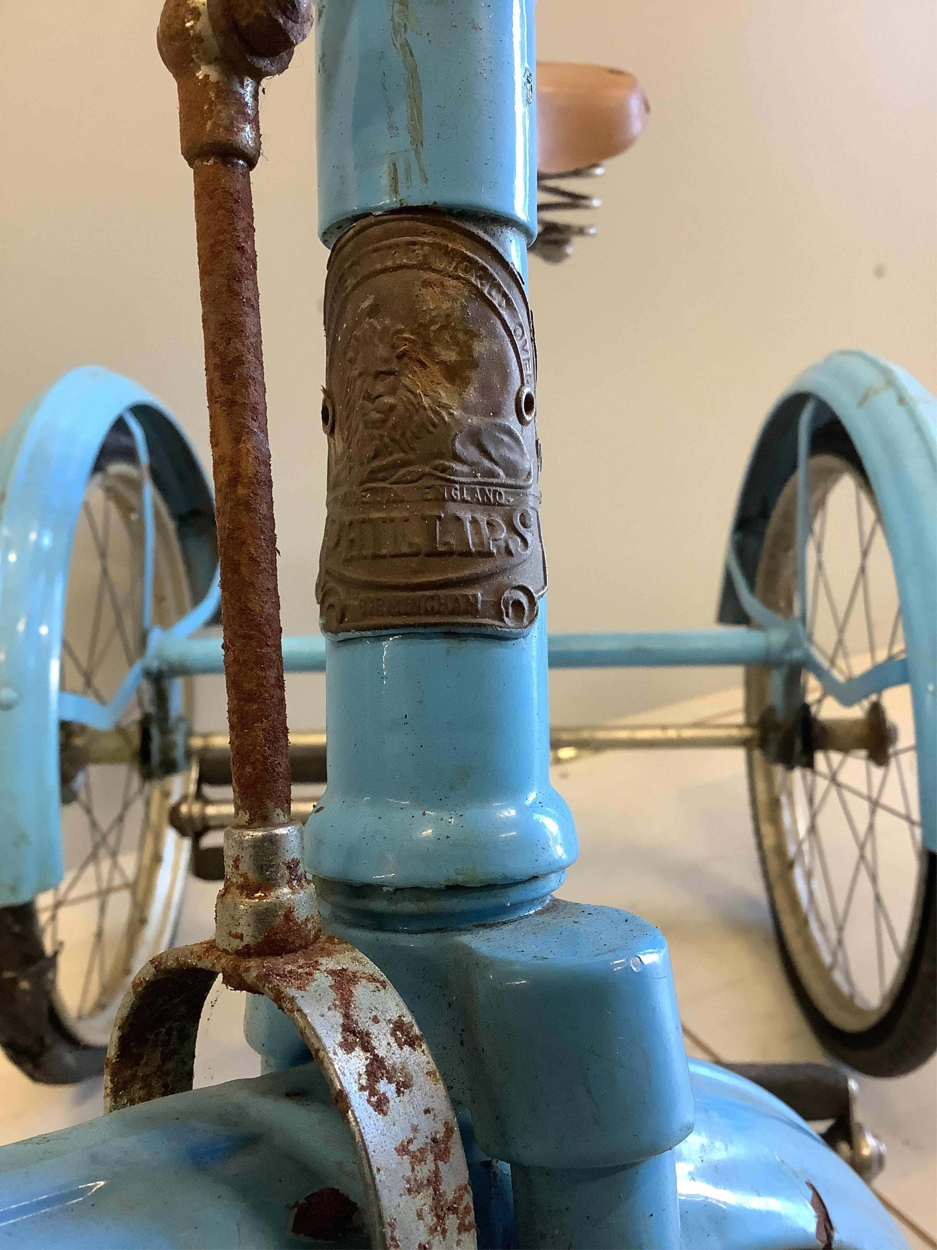 A vintage tricycle by Phillips Birmingham, length 110cm, height 73cm. Condition - fair